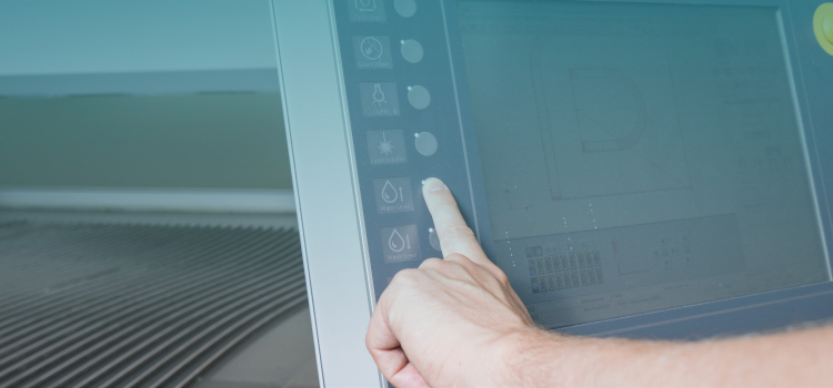 Anyone-Can-Program-a-Waterjet-panel.jpg Hand hovering over the screen/panel of a controller