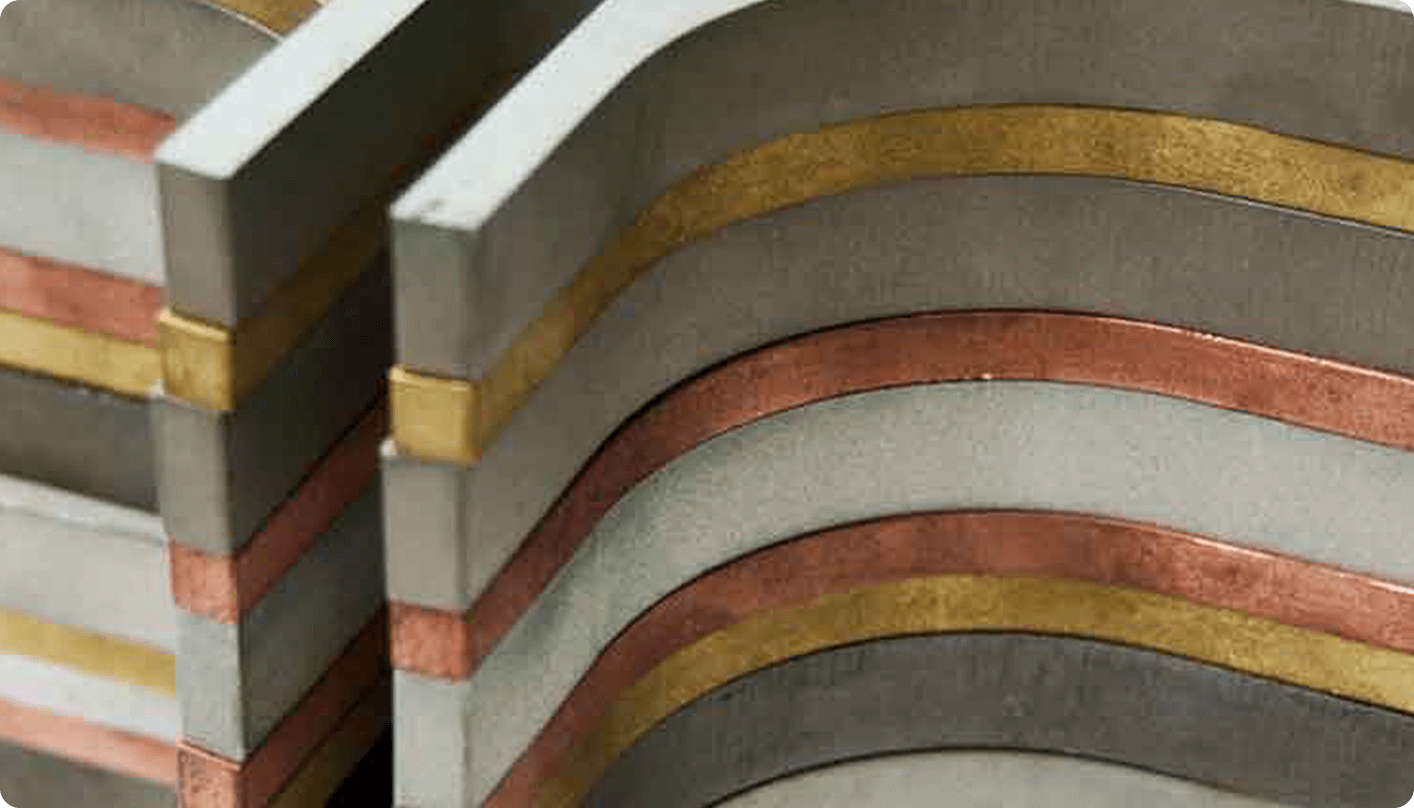 a closeup image of multiple stacked materials after being cut with a waterjet