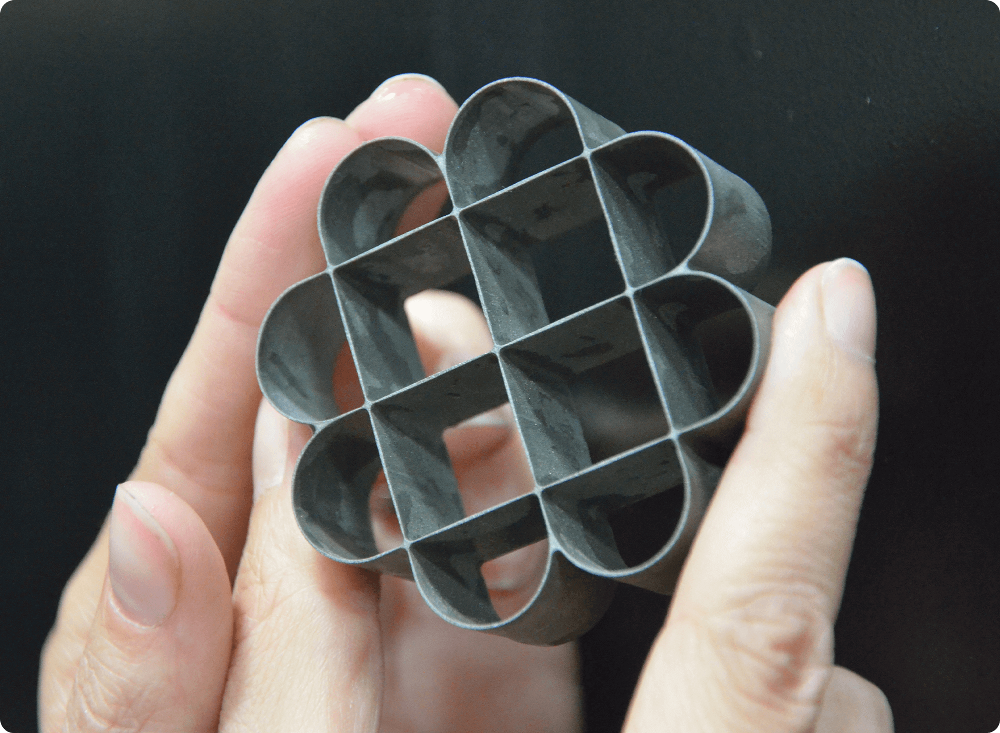 hand holding thin geometric flower cut part