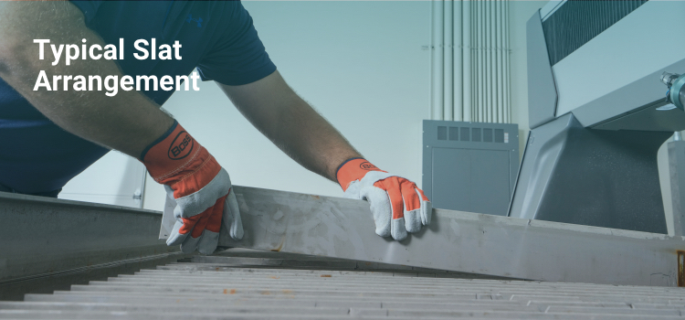 individual installing a slat in a waterjet table at regular intervals