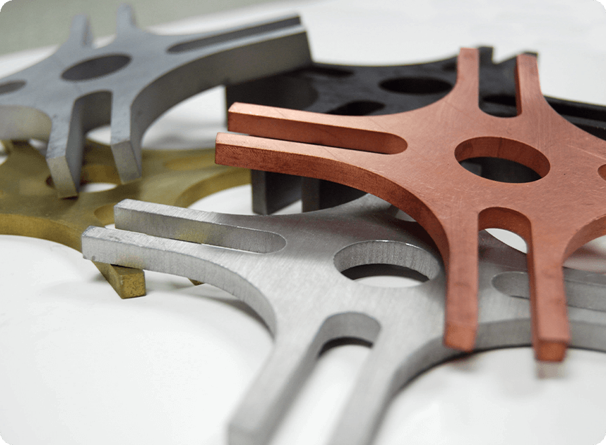 Various metal parts - brass, copper, aluminum on a Flow waterjet table