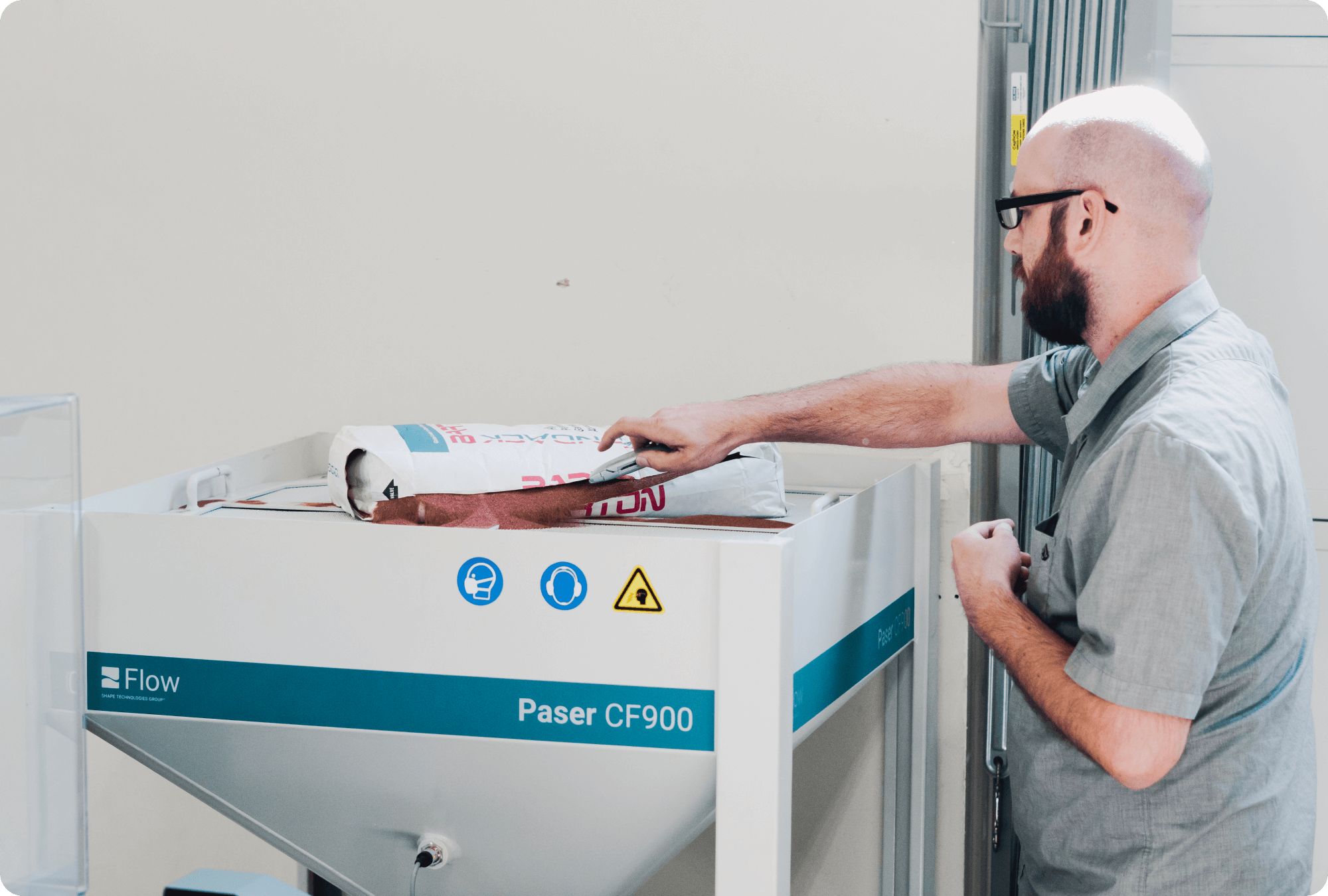 Man pouring abrasive into the PASER CF900 hopper