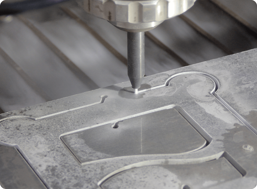 closeup of nanojet cutting a flow logo into metal material
