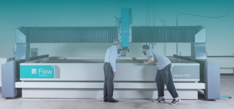 two people standing in front of waterjet table